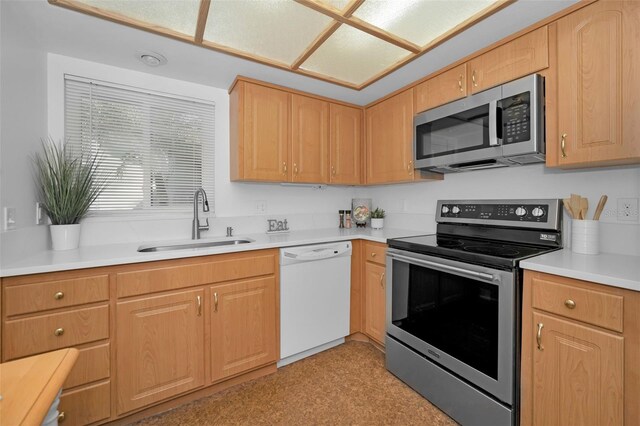 kitchen with sink, light brown cabinets, and appliances with stainless steel finishes