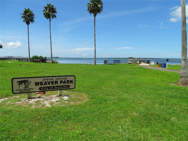 view of home's community featuring a water view and a lawn