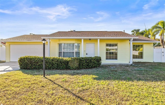 view of front of property with a garage and a front yard