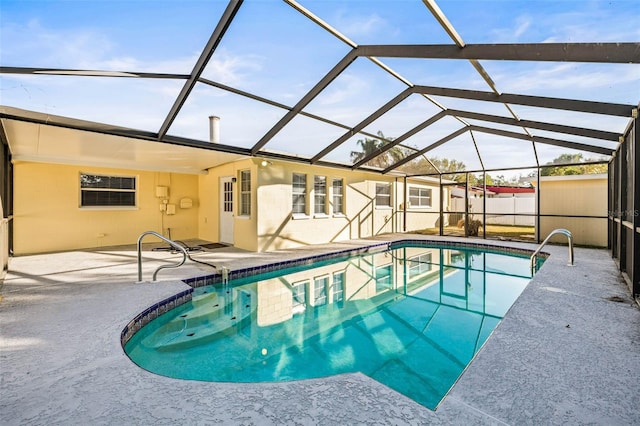 view of swimming pool featuring a lanai and a patio area