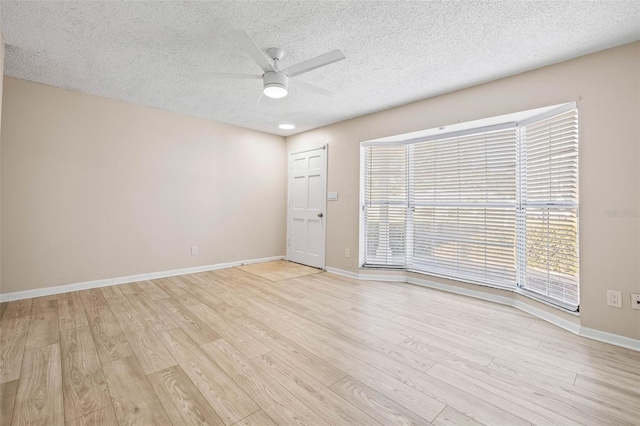 unfurnished room with ceiling fan, light hardwood / wood-style floors, and a textured ceiling