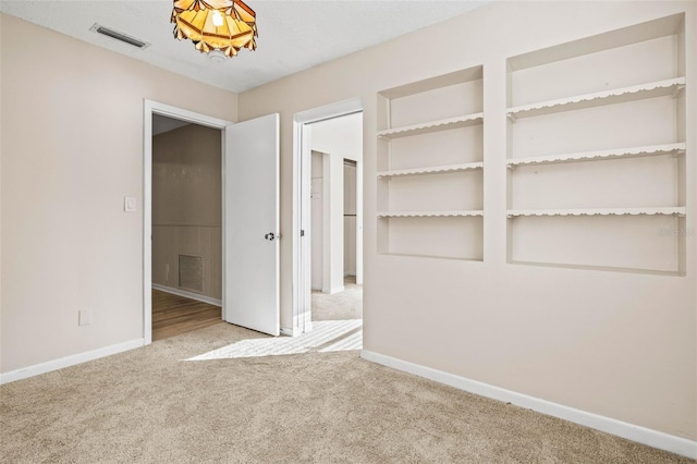 unfurnished bedroom featuring light colored carpet