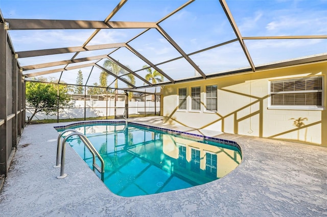 view of swimming pool with a patio area and a lanai