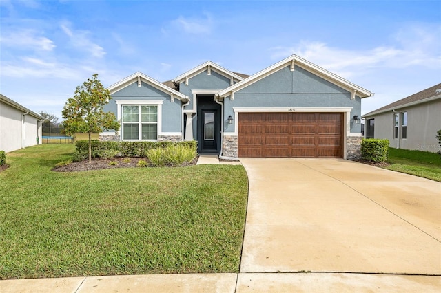 view of front of home with a front yard and a garage