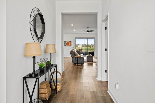 corridor with hardwood / wood-style floors