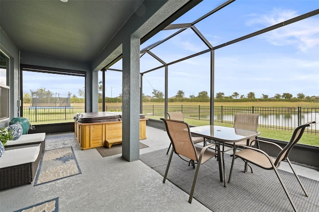 sunroom with plenty of natural light and a water view