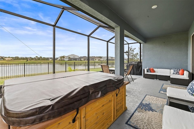 view of patio featuring outdoor lounge area, a lanai, a grill, a hot tub, and a water view