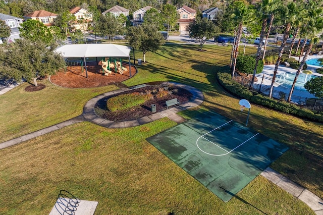 view of basketball court with a yard