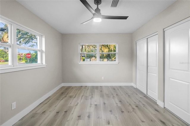 unfurnished bedroom featuring ceiling fan and light wood-type flooring