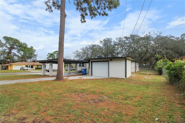 view of front of home with a garage, a front yard, and a carport