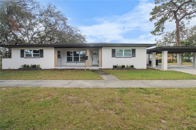 ranch-style house with a front yard and a carport