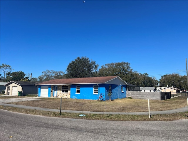 ranch-style home with a garage and a front yard