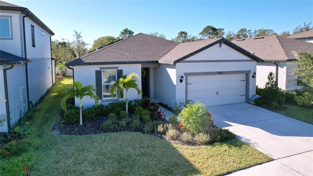 view of front of home with a garage and a front lawn