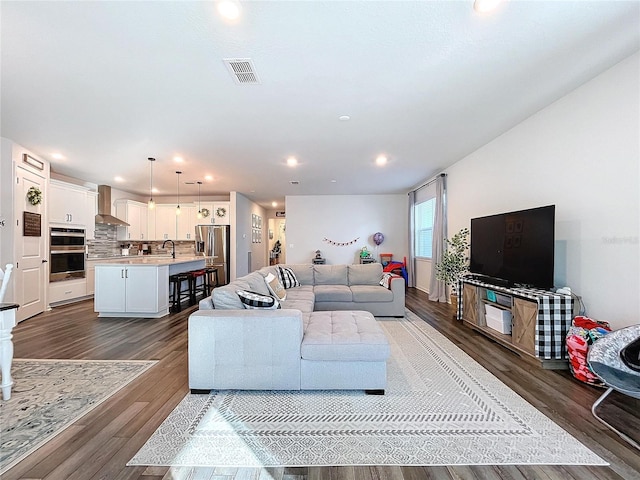 living room with sink and dark hardwood / wood-style floors