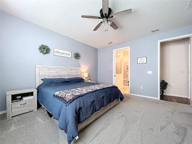 bedroom featuring carpet, ensuite bath, and ceiling fan