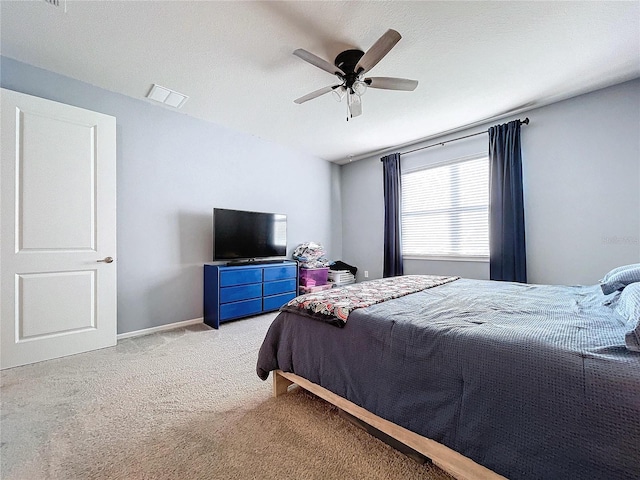 carpeted bedroom featuring a textured ceiling and ceiling fan