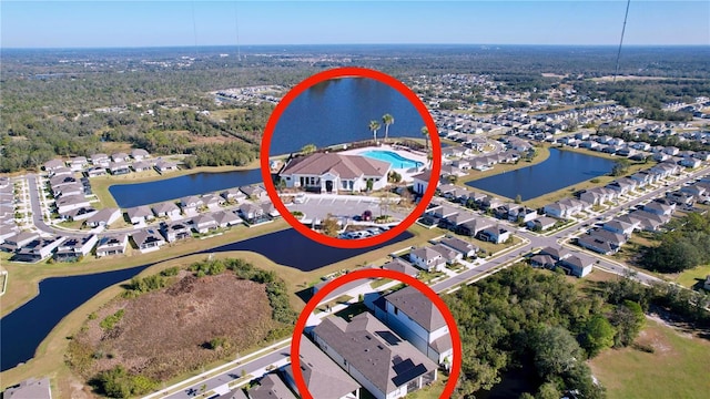 birds eye view of property with a water view