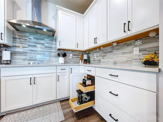 kitchen featuring white cabinetry, dark wood-type flooring, wall chimney range hood, backsplash, and black cooktop