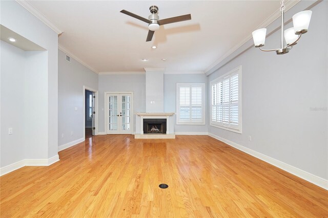 unfurnished living room with french doors, light hardwood / wood-style floors, ceiling fan with notable chandelier, and ornamental molding