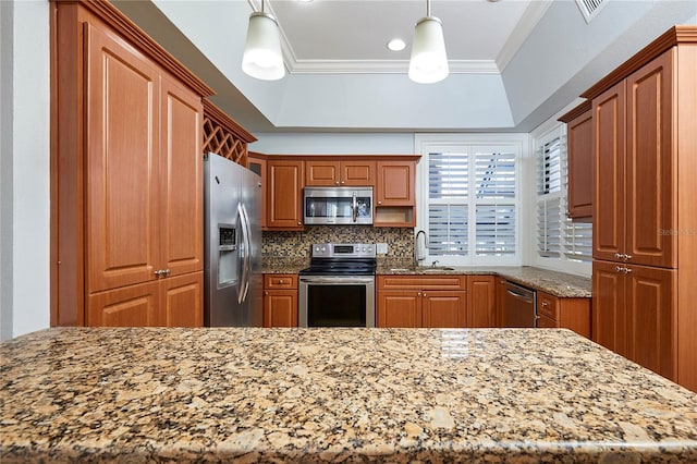 kitchen featuring pendant lighting, backsplash, sink, ornamental molding, and appliances with stainless steel finishes