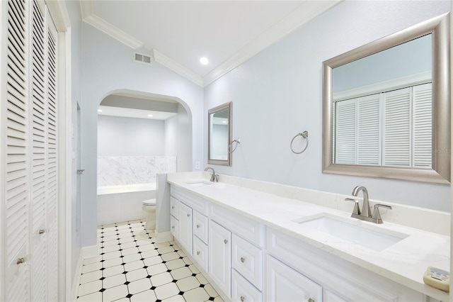 bathroom with ornamental molding, vanity, vaulted ceiling, a bath, and toilet