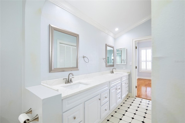 bathroom featuring vanity, lofted ceiling, and ornamental molding