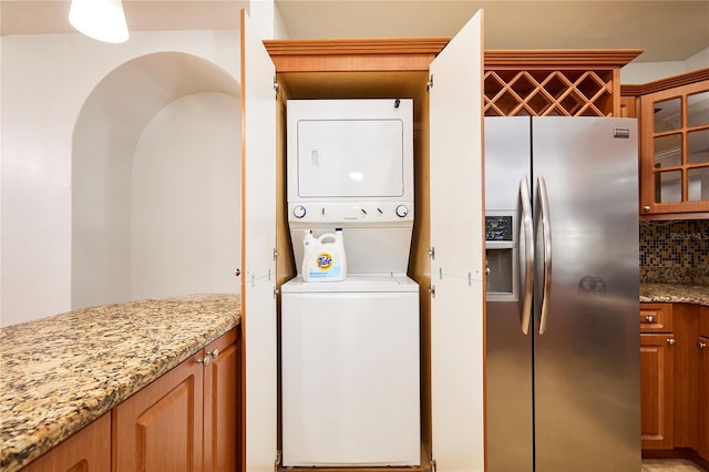 clothes washing area with stacked washer / drying machine