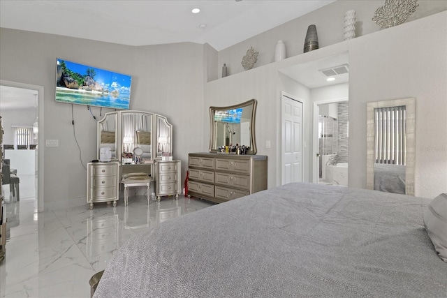 bedroom with ensuite bath, a closet, and lofted ceiling