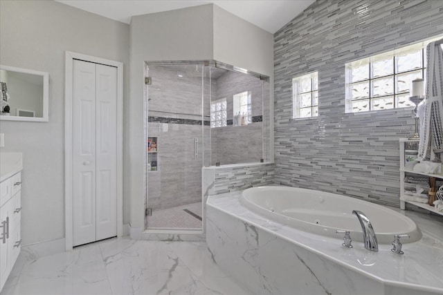 bathroom featuring shower with separate bathtub and vanity