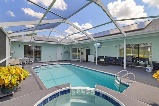 view of pool with outdoor lounge area, a patio, and an in ground hot tub