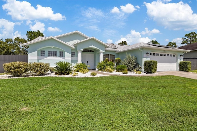 ranch-style home with a garage and a front yard