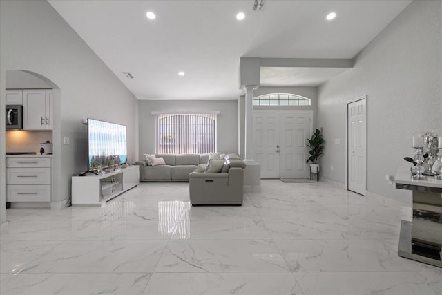 living room featuring a towering ceiling