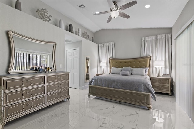 bedroom featuring a closet, ceiling fan, and lofted ceiling