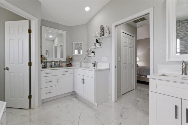 bathroom with vanity and vaulted ceiling