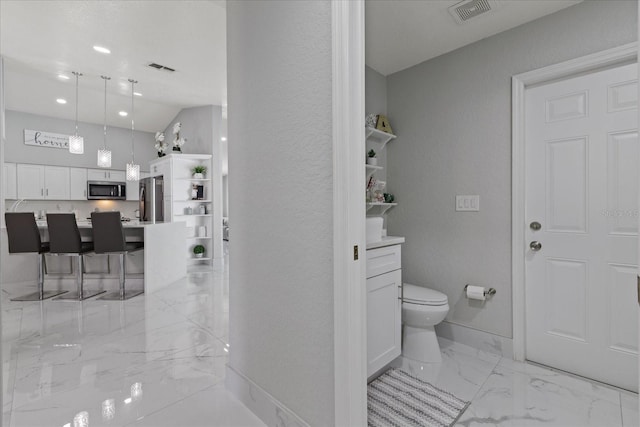 bathroom featuring vaulted ceiling and toilet