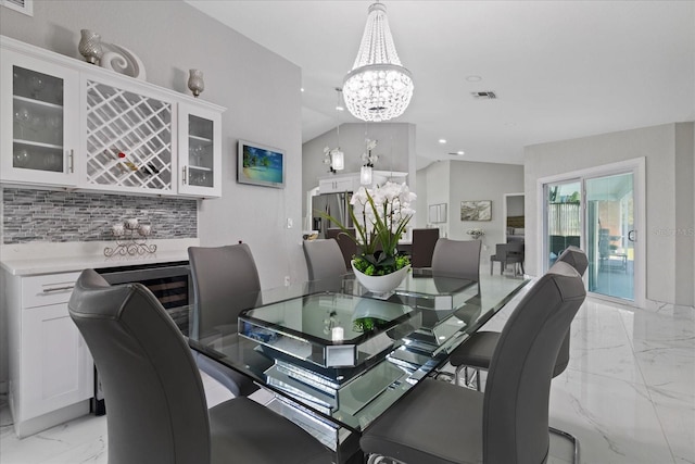 dining room with lofted ceiling and an inviting chandelier