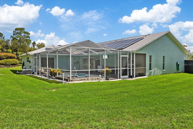 rear view of property with a lanai and a lawn