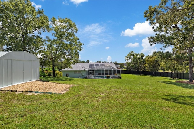 view of yard with a lanai and a shed