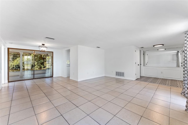 interior space with a notable chandelier and light tile patterned floors