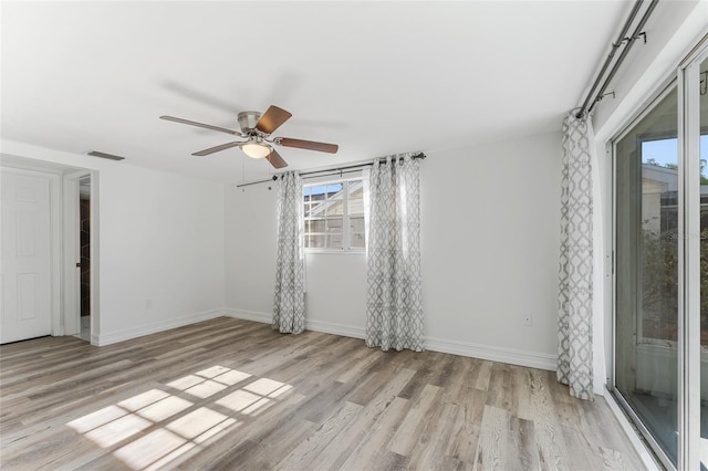 spare room with light hardwood / wood-style floors and ceiling fan