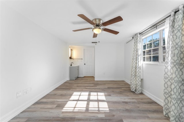 unfurnished bedroom with light hardwood / wood-style flooring and ceiling fan