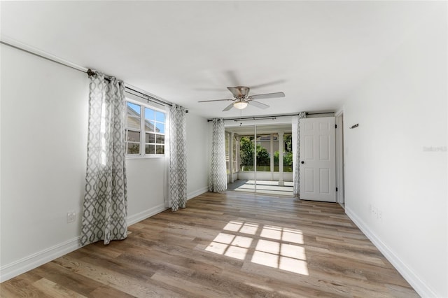 unfurnished room featuring light hardwood / wood-style floors and ceiling fan