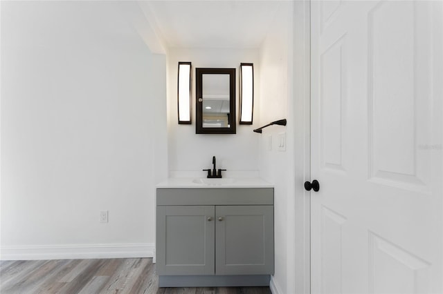 bathroom with hardwood / wood-style floors and vanity