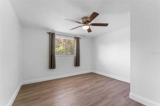 empty room with light hardwood / wood-style floors and ceiling fan