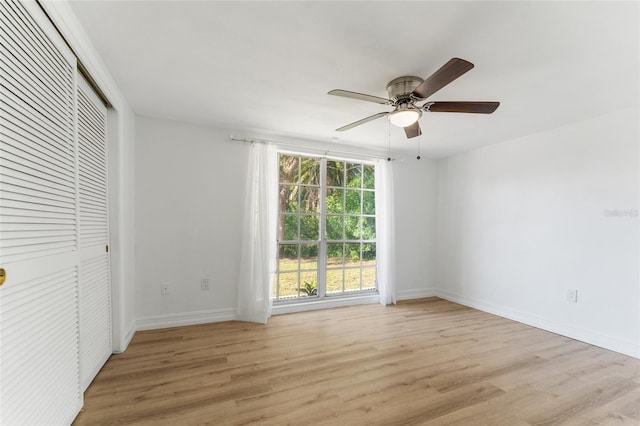 unfurnished bedroom with ceiling fan, a closet, and light hardwood / wood-style floors