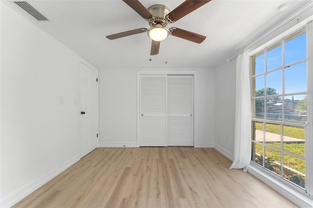 unfurnished bedroom featuring a closet, ceiling fan, and light hardwood / wood-style flooring