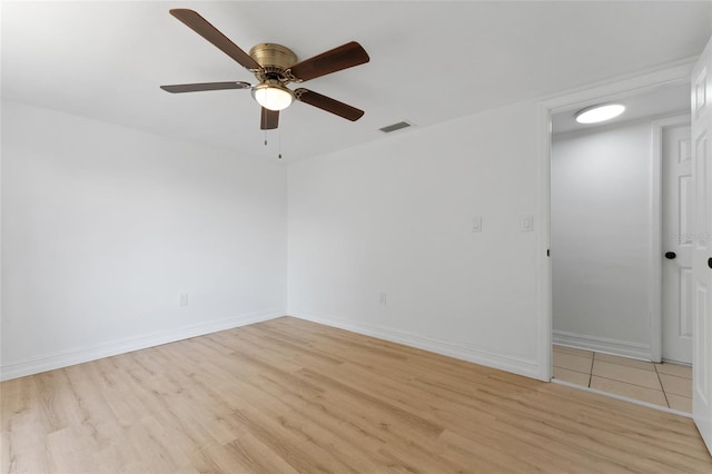 empty room with ceiling fan and light hardwood / wood-style floors