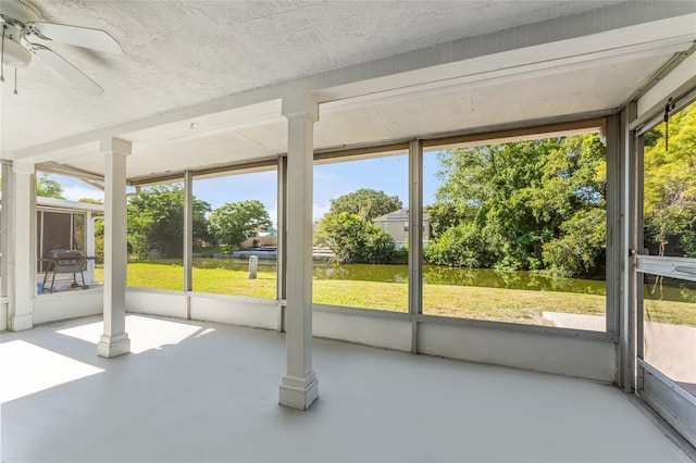 unfurnished sunroom featuring ceiling fan