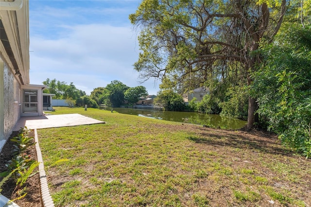 view of yard featuring a water view and a patio