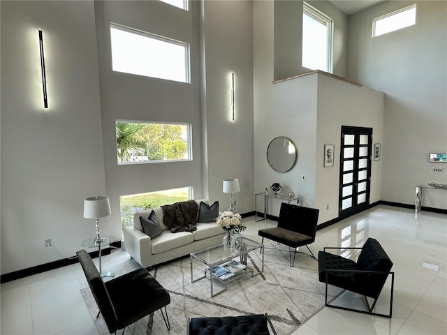 living room with light tile patterned floors and a towering ceiling